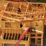 In an aerial view, construction workers build a home at a new housing development on July 1, 2025 in Hercules, Calif.
