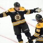 Boston Bruins defenseman Hampus Lindholm, left, celebrates his goal with right wing David Pastrnak, right, in the first period of an NHL hockey game against the Calgary Flames, Thursday, Nov. 7, 2024, in Boston.