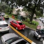 Cars wait in line to get into the parking lot for gas at Costco, Monday, Oct. 7, 2024, in Altamonte Springs, Fla., as residents prepare for the impact of approaching Hurricane Milton.