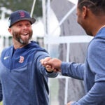 Former Red Sox second baseman Dustin Pedroia was in camp today, he is pictured as he says hello to Rafael Devers (right). The Boston Red Sox continued Spring Training workouts at their Fenway South Complex.