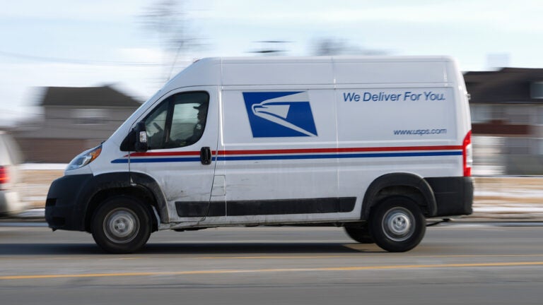 A United States Postal Service truck drives through Detroit.